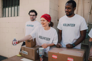 Volunteers handing out donated goods by Pexels 320 x 213